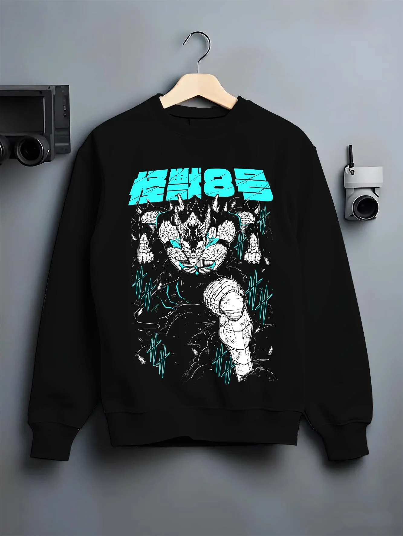 Black crewneck sweatshirt on hanger with Kaiju No. 8 Hoodie Monstrous Power Surge Pose graphic premium wear.