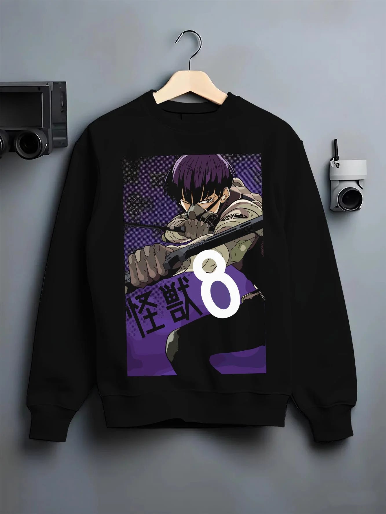 Black crewneck sweatshirt on hanger with Kaiju No. 8 Hoodie Squad Fighters Ready for Battle graphic bold anime graphic.