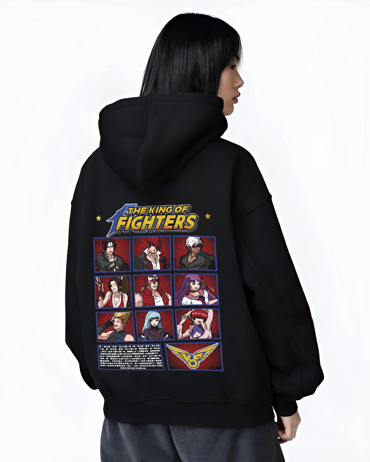 Black hoodie worn by female model from the back featuring King of Fighters character roster artwork.