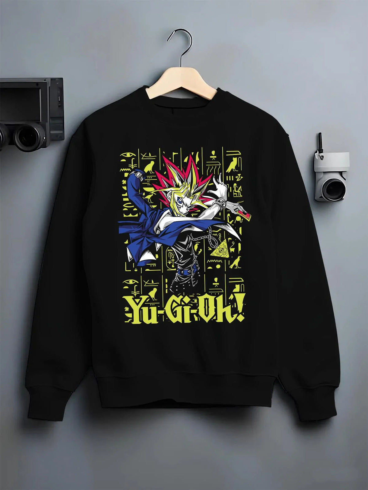 Black crewneck sweatshirt on hanger featuring Yugi King of Games Millennium Puzzle artwork.