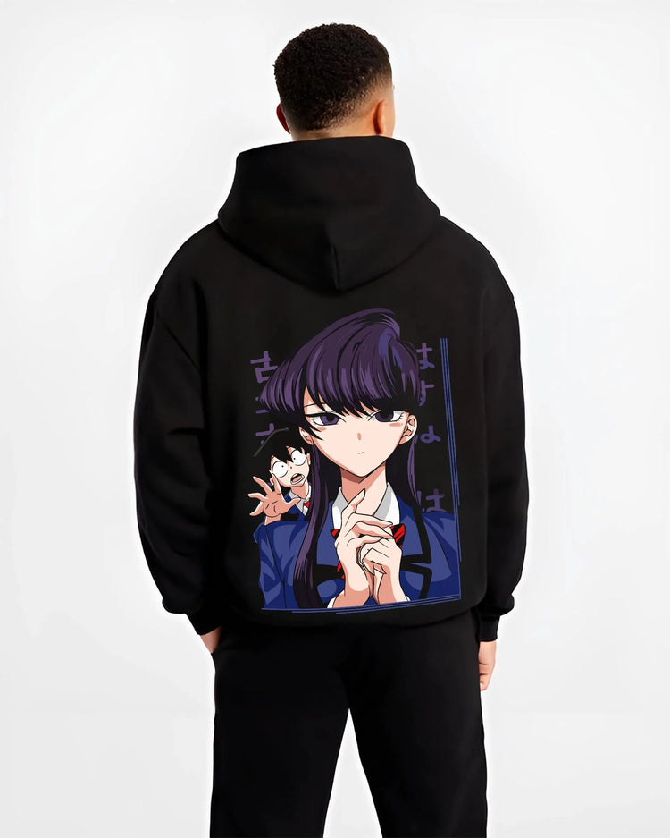 Black hoodie worn by male model, back view with Komi Can’t Communicate Hoodie Shouko Komi School Uniform graphic bold anime graphic.