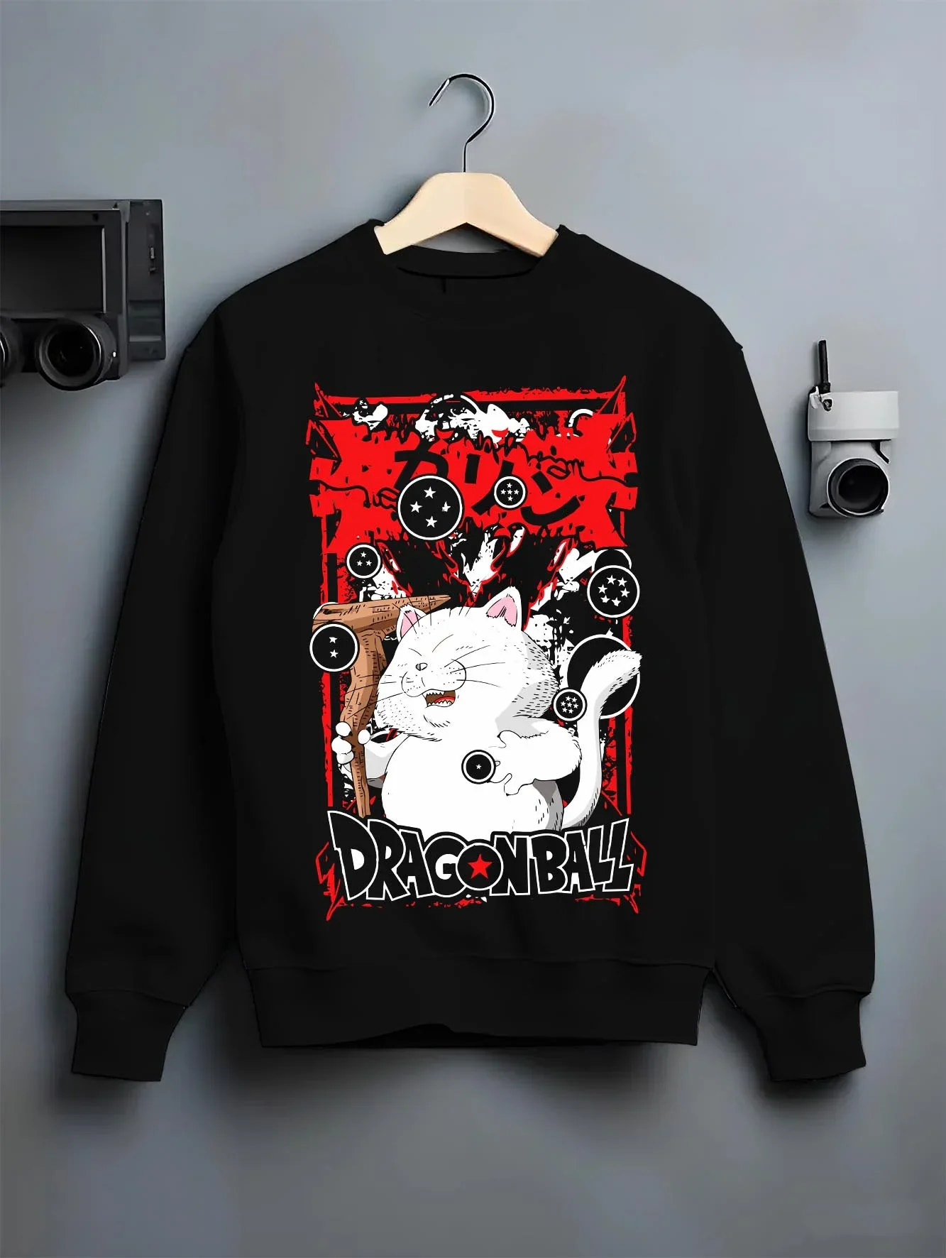 Black crewneck sweatshirt on hanger with Dragon Ball Hoodie Korin Tower Guardian Cat graphic bold anime graphic.