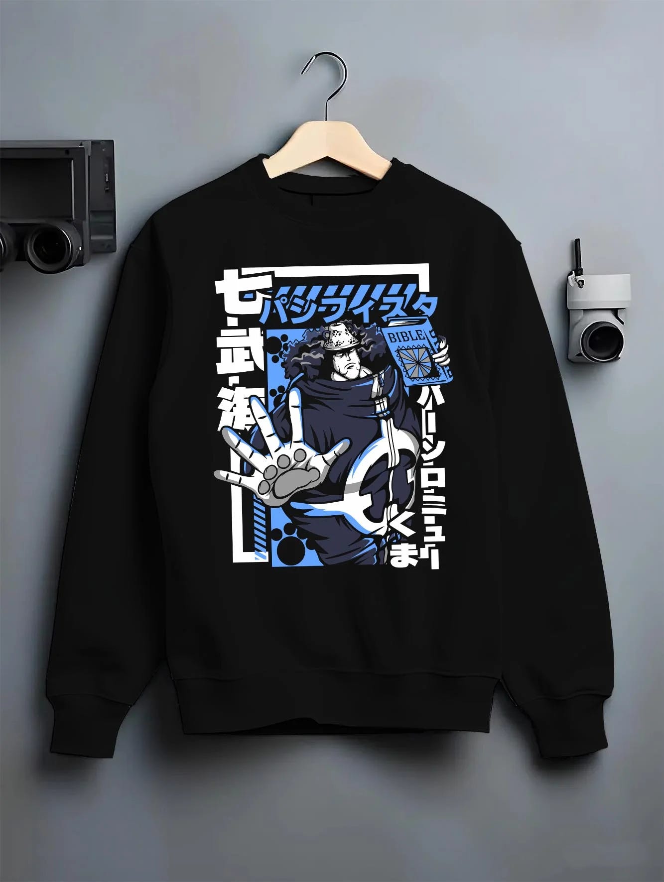 Black crewneck sweatshirt on hanger with Bartholomew Kuma One Piece Hoodie Revolutionary Anime graphic streetwear graphic.