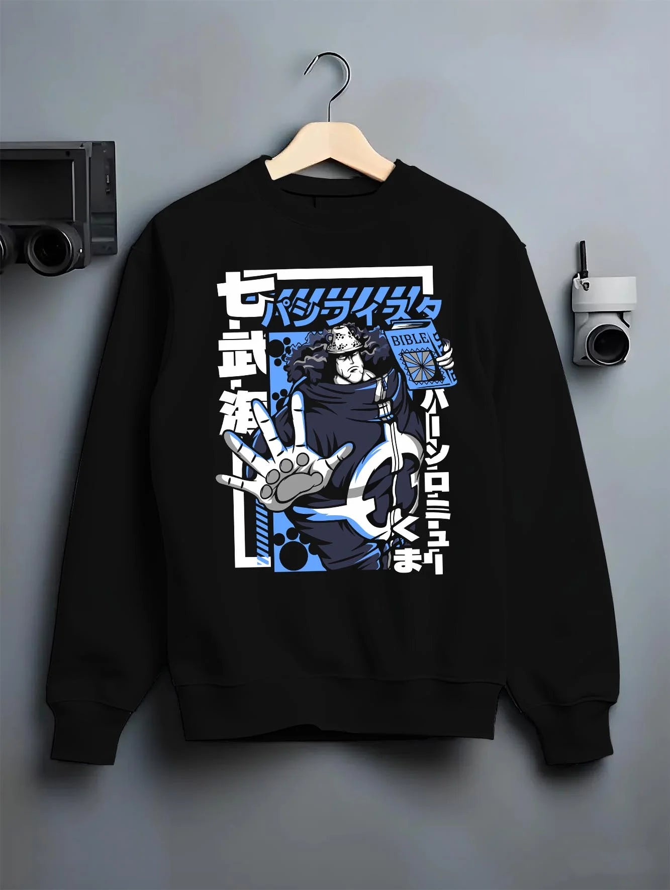 Black crewneck sweatshirt on hanger with Bartholomew Kuma One Piece Hoodie Revolutionary Anime graphic streetwear graphic.