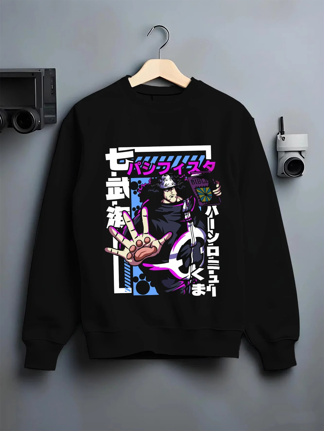 Black crewneck sweatshirt on hanger with One Piece Hoodie Bartholomew Kuma Pacifista Power graphic bold anime graphic.