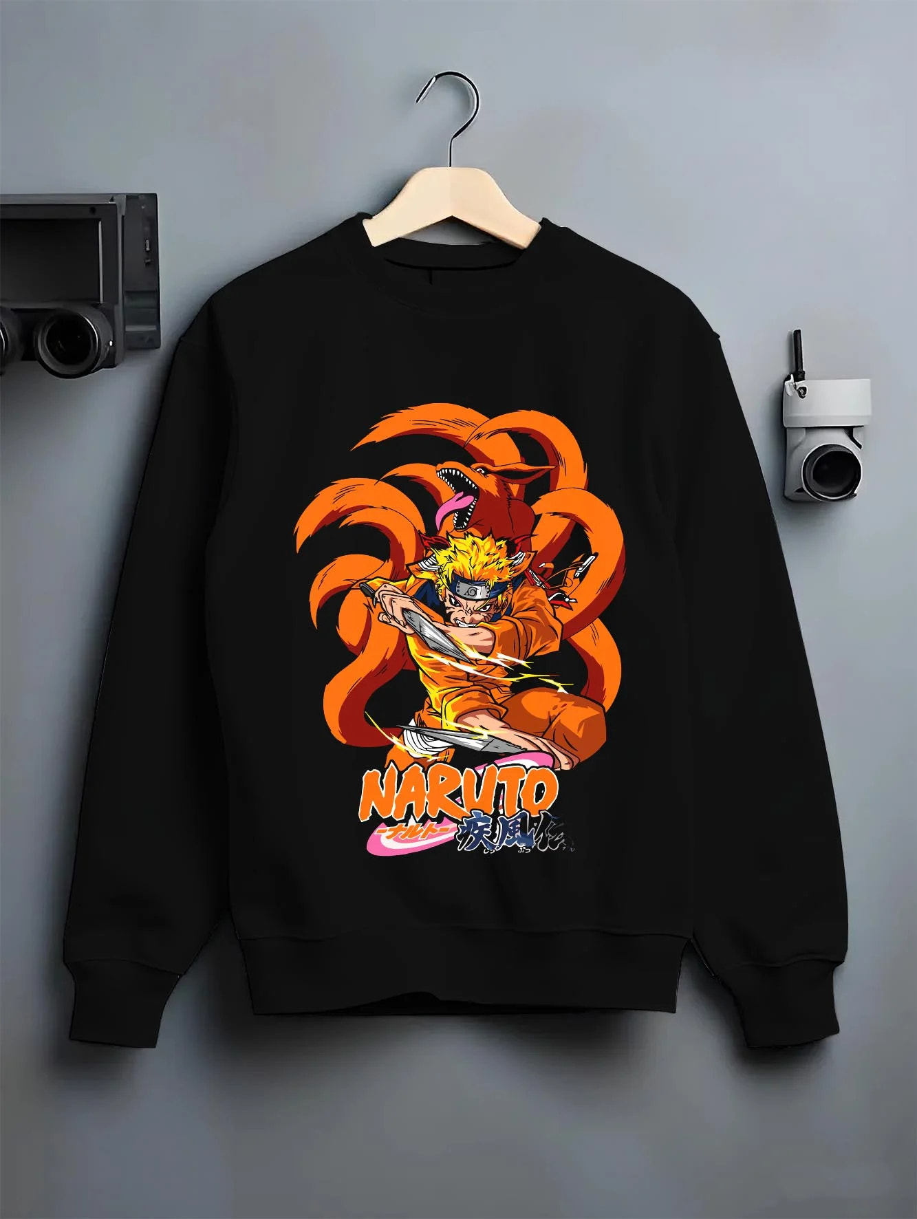 Black crewneck sweatshirt on hanger with Kaiju No. 8 Monster Transformation Hoodie Epic Battle graphic premium wear.