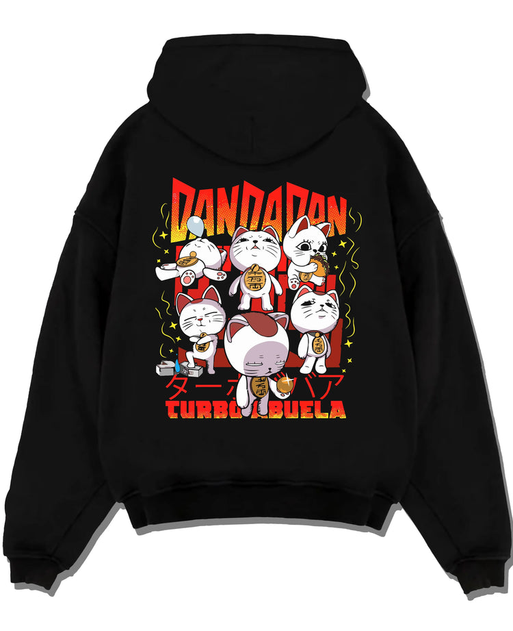 Black pullover hoodie laid flat with Dandadan Turbo Granny Hoodie Cat Spirits Anime Jumper graphic bold anime graphic.