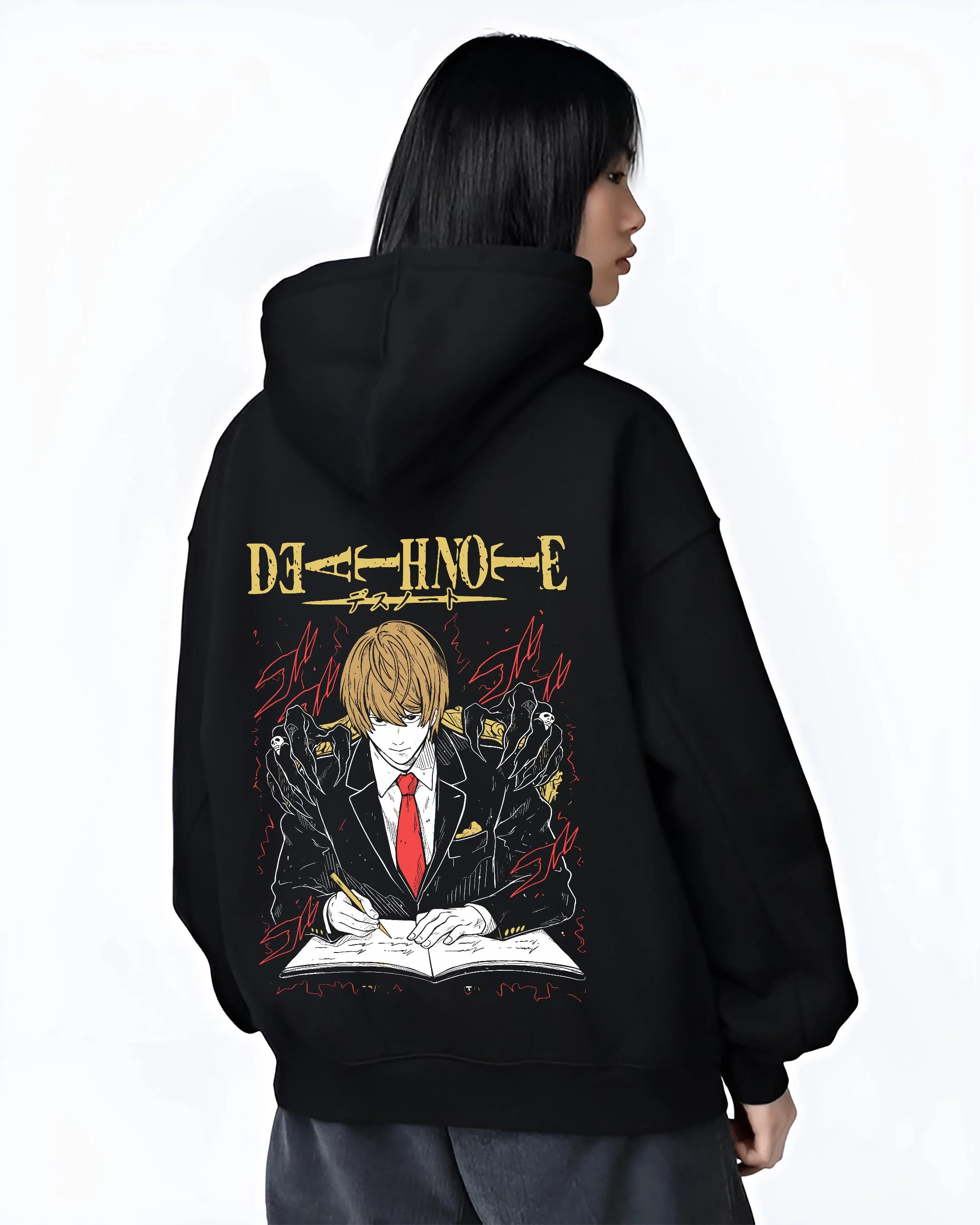 Black hoodie worn by female model, back view with Light Yagami Hoodie Death Note Kira Retro Villain graphic streetwear graphic.