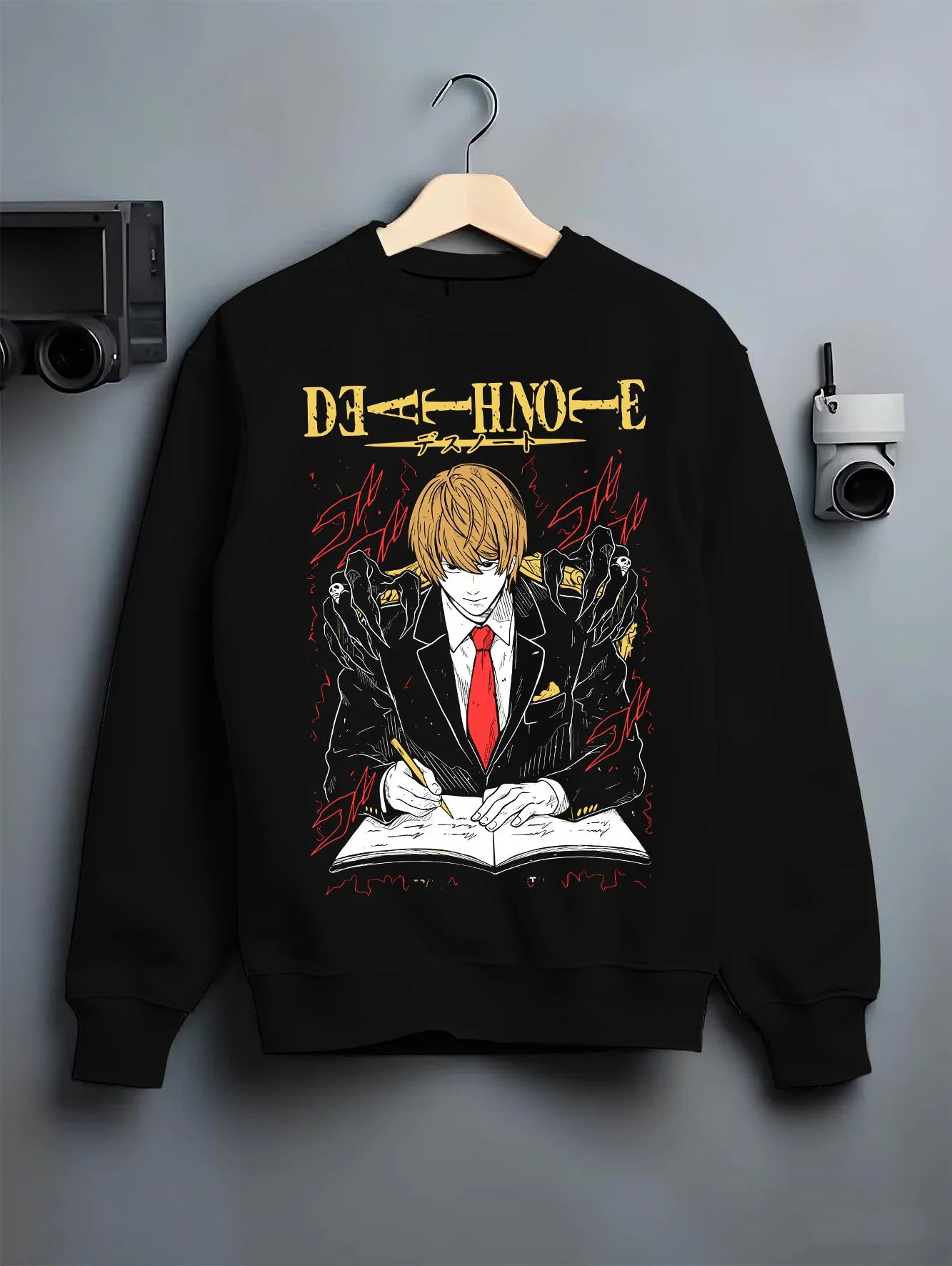 Black crewneck sweatshirt on hanger with Light Yagami Hoodie Death Note Kira Retro Villain graphic streetwear graphic.