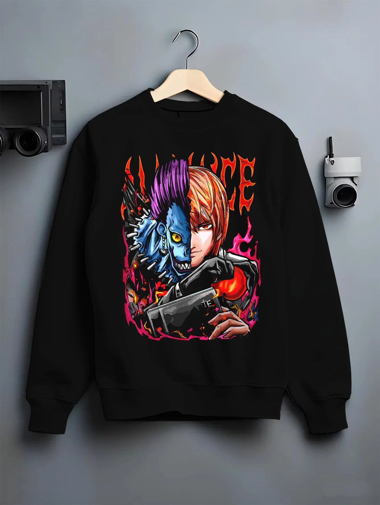 Black crewneck sweatshirt on hanger with Ryuk Light Hoodie Death Note Kira Shinigami Duo graphic bold anime graphic.