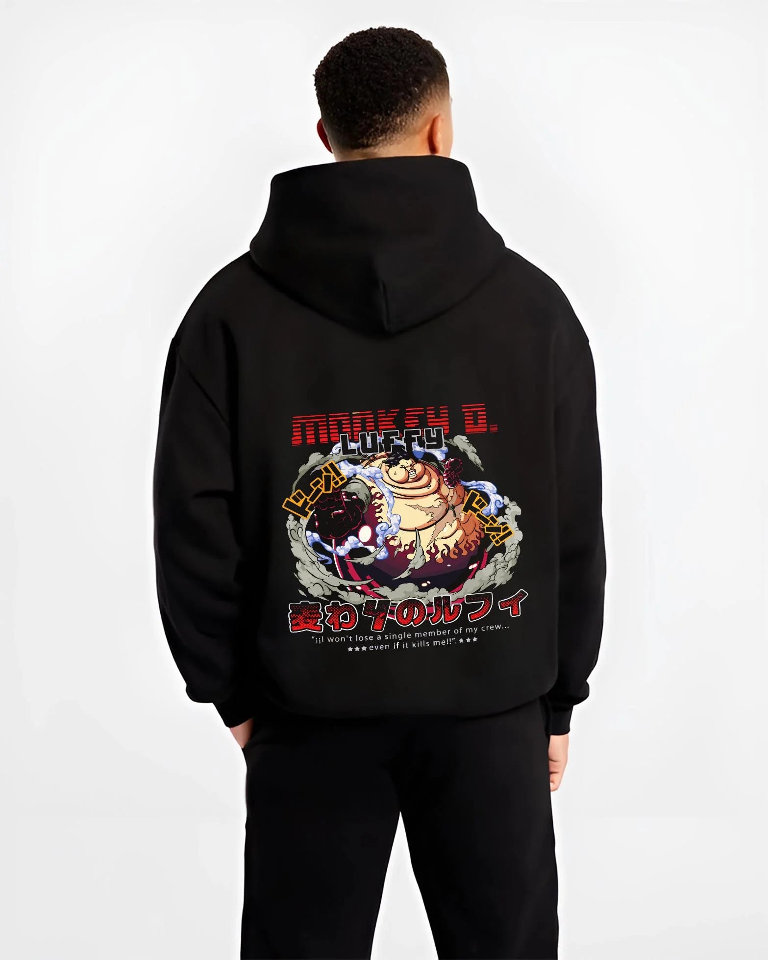 Black hoodie worn by a male model, back view, featuring Monkey D. Luffy Gear Fourth retro manga artwork print from One Piece.