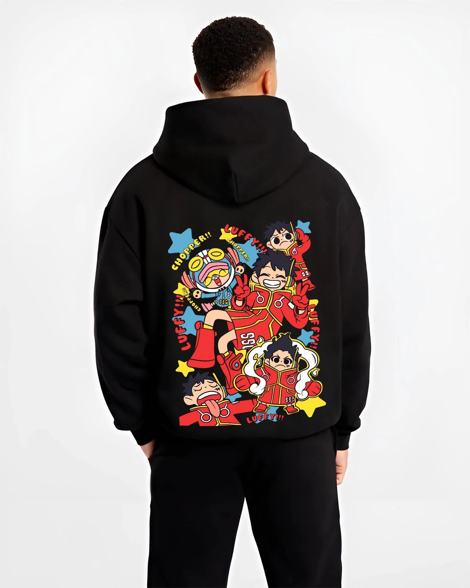 Black hoodie worn by male model, back view highlighting colourful One Piece Luffy and Chopper anime poster inspired streetwear artwork.