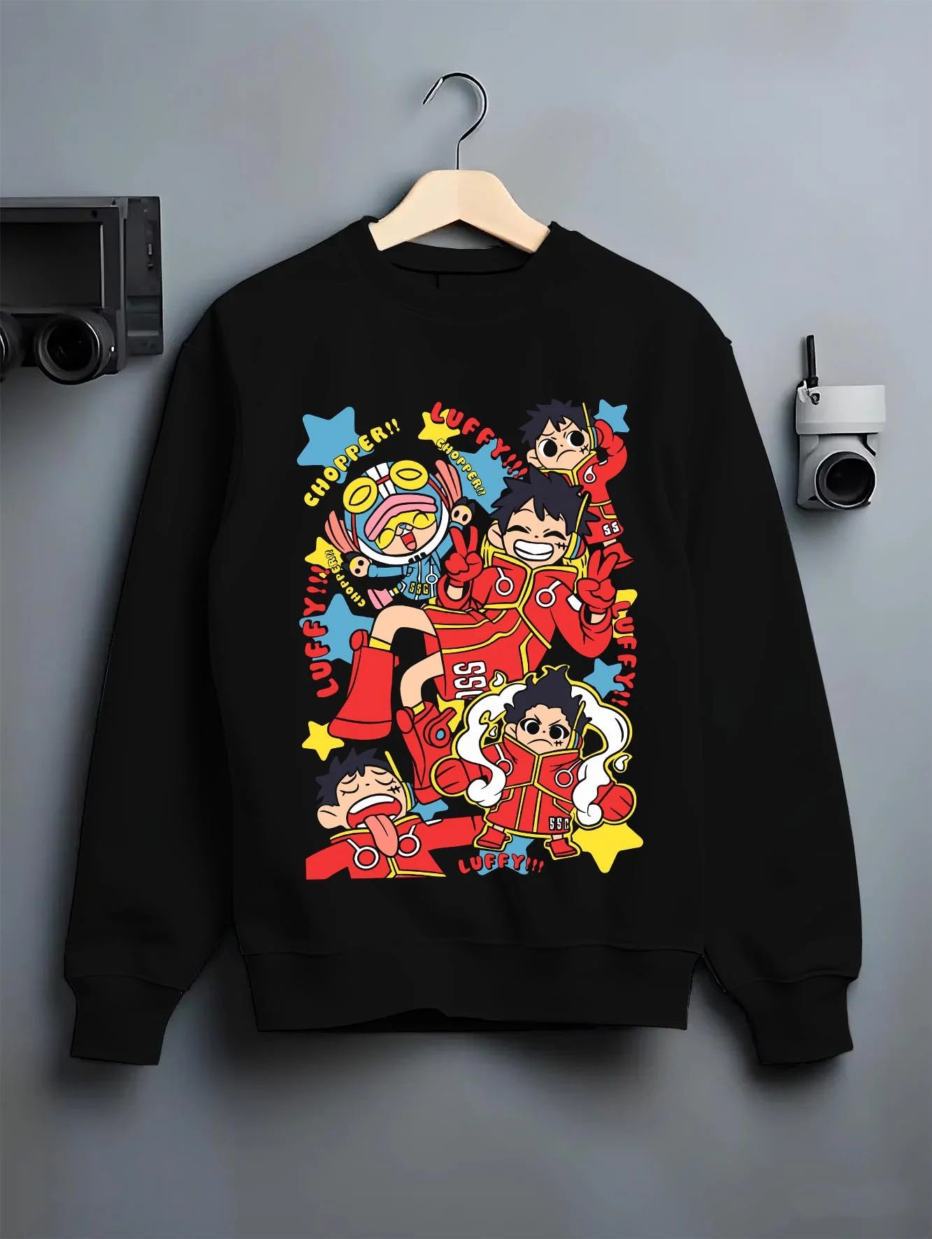 Black crewneck sweatshirt on hanger featuring nostalgic 90s graphic style with Luffy and Chopper anime poster inspired streetwear print.