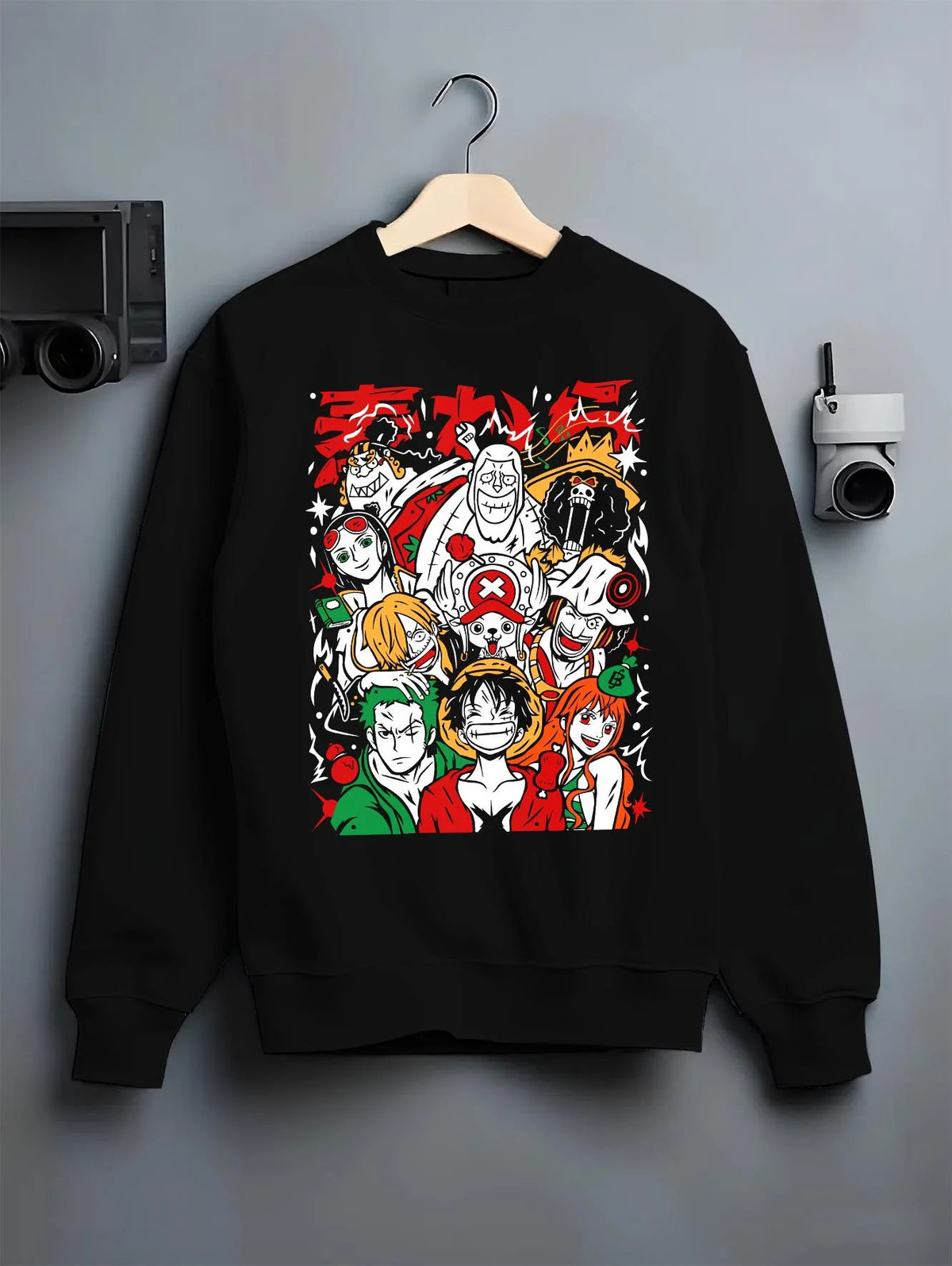 Black crewneck sweatshirt on hanger featuring Luffy and the Straw Hat crew artwork.