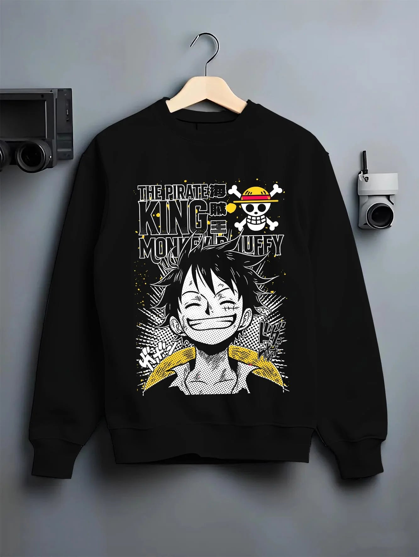 Black crewneck sweatshirt on hanger with One Piece Bartholomew Kuma Pacifista Hoodie graphic bold anime graphic.