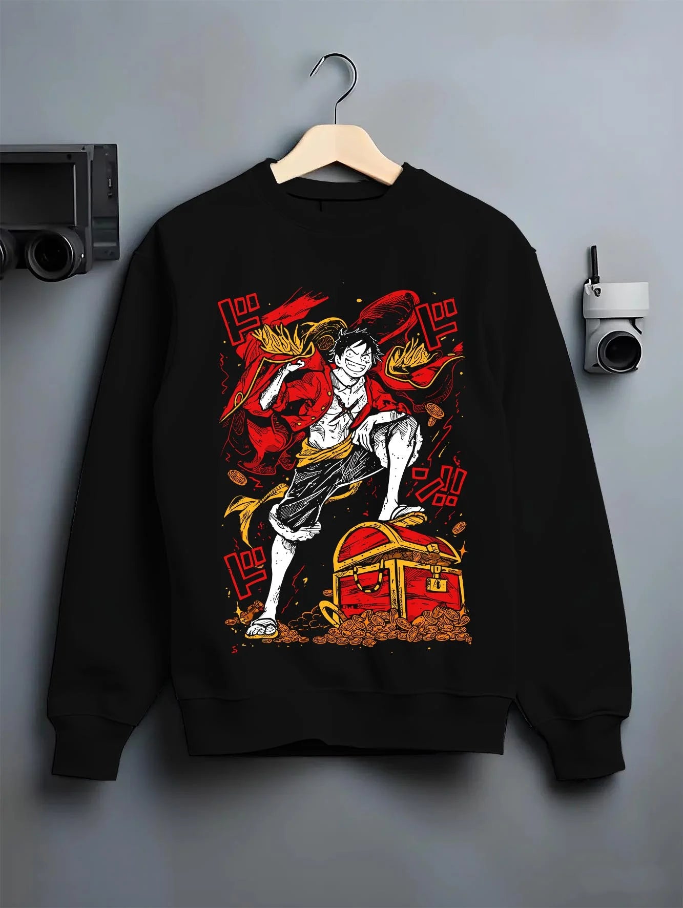 Black crewneck sweatshirt on hanger with Monkey D. Luffy Hoodie One Piece Pirate King graphic streetwear graphic.