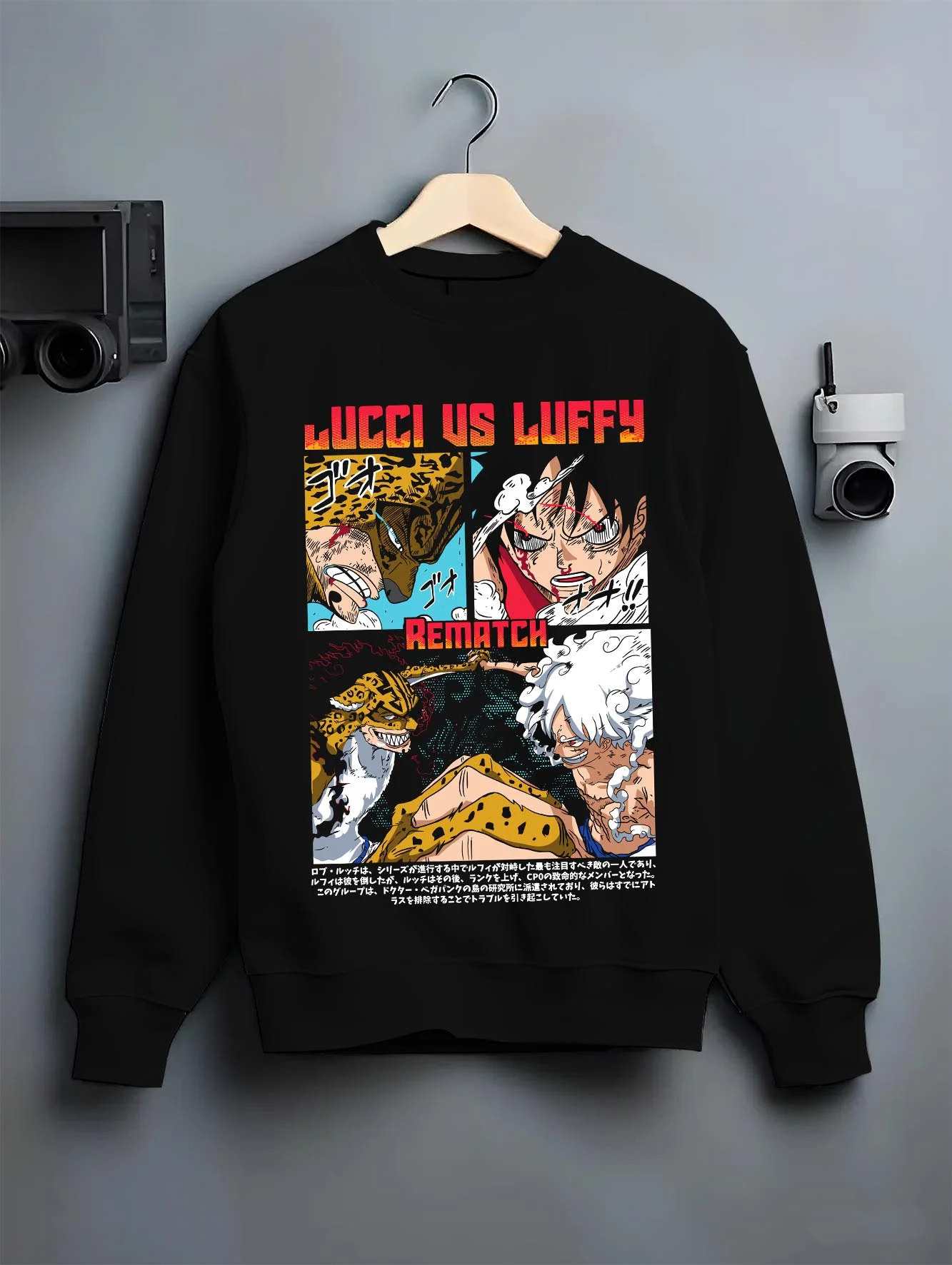 Black crewneck sweatshirt on hanger with Luffy vs Lucci Hoodie One Piece Rematch Epic graphic premium wear.