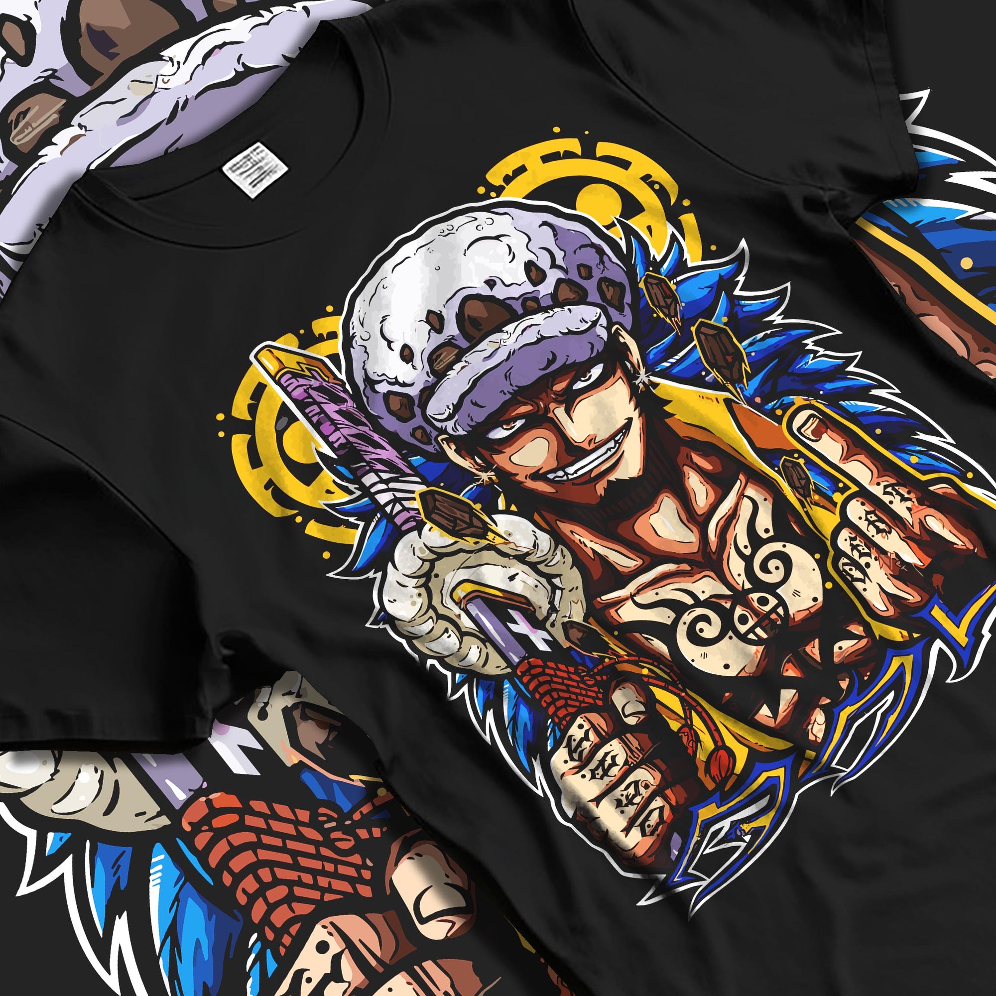 Black T-shirt laid flat with natural fabric folds, featuring Trafalgar Law anime poster design with sword and bold outline accents.