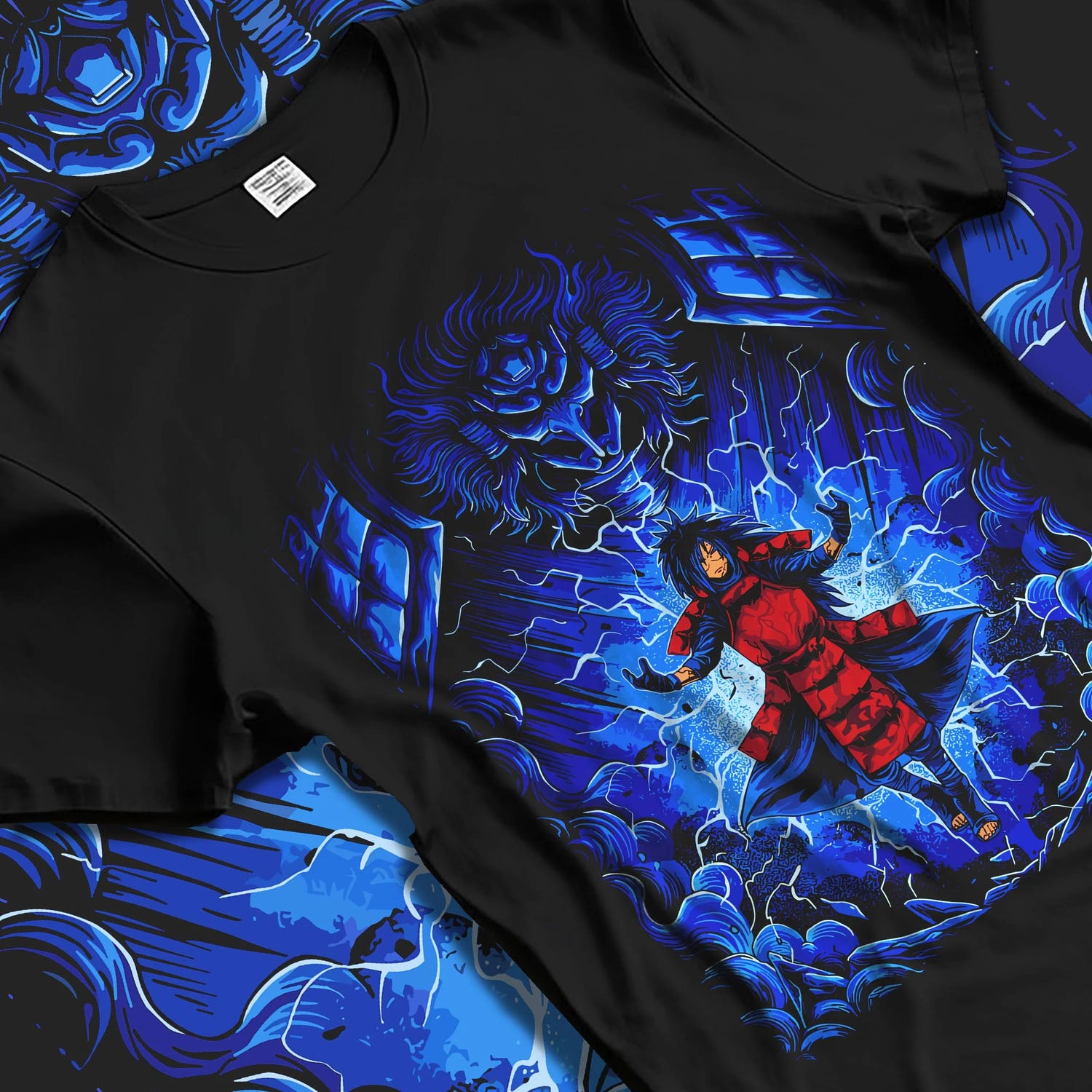 Black T-shirt laid flat with natural folds with Madara Uchiha Hoodie Naruto Legendary Power graphic bold anime graphic.