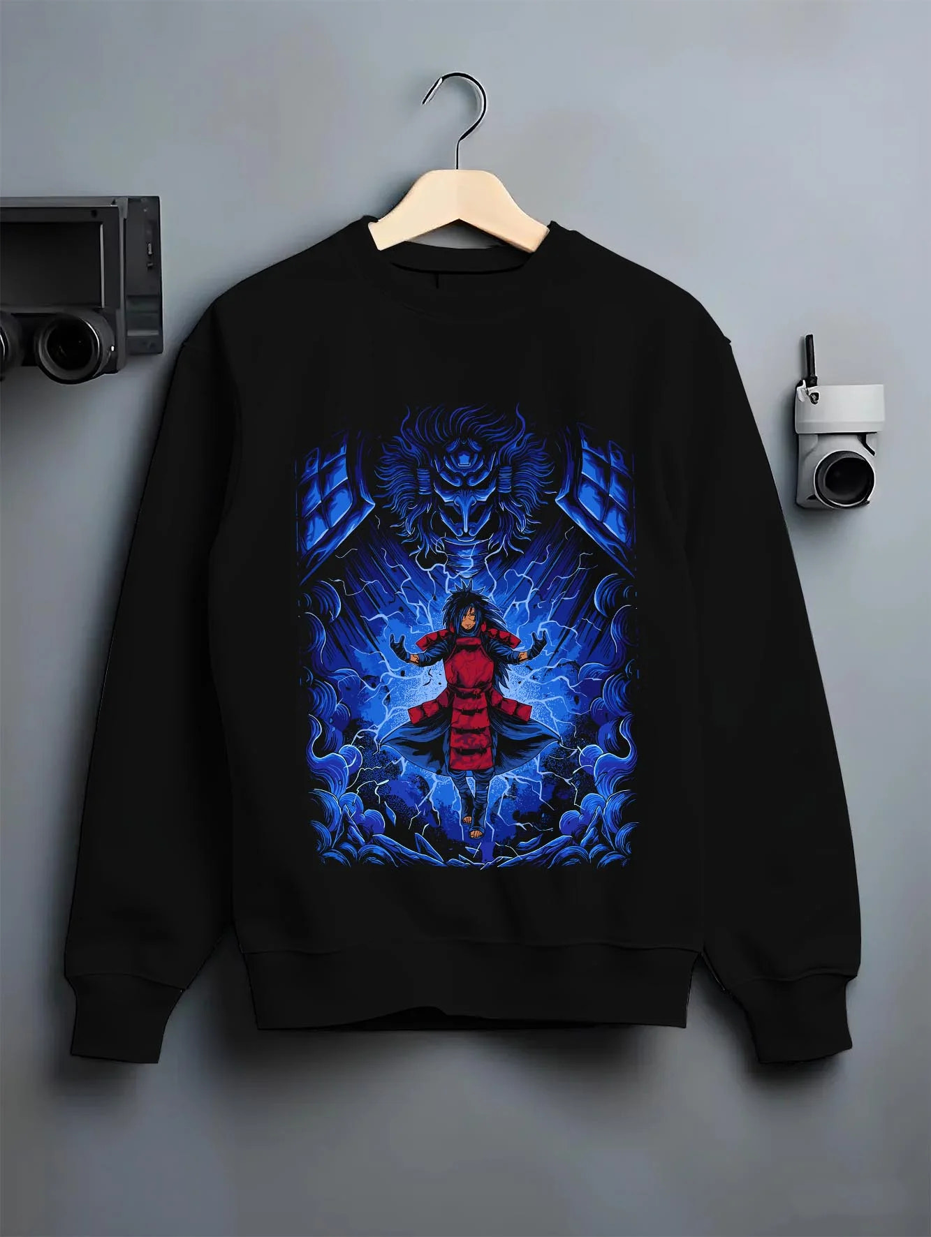 Black crewneck sweatshirt on hanger with Madara Uchiha Hoodie Naruto Legendary Power graphic streetwear graphic.