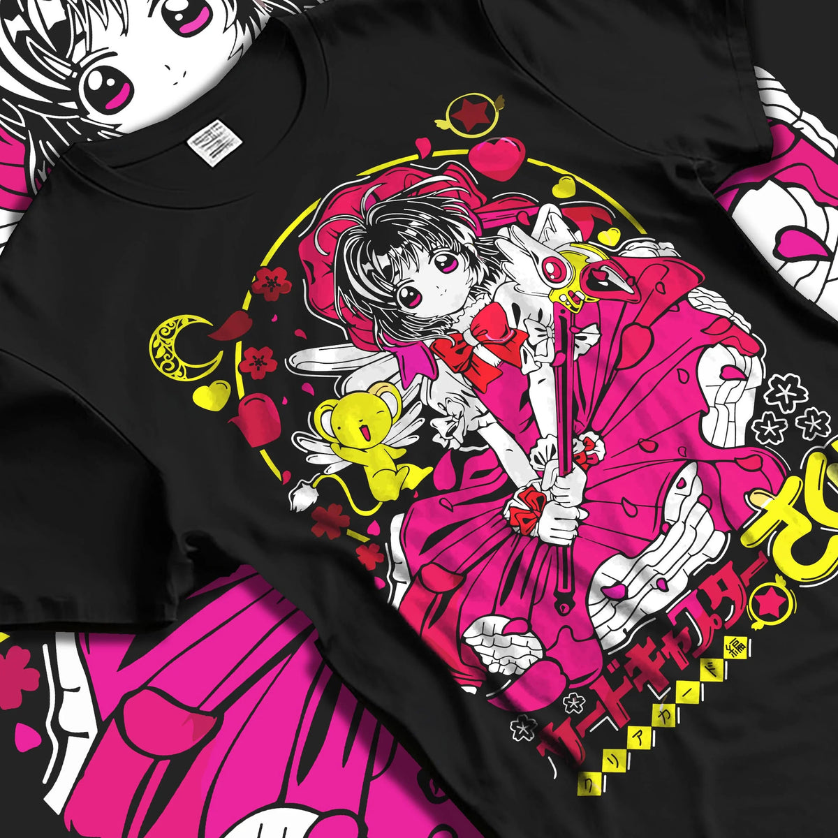 Black T-shirt laid flat with natural folds featuring Sakura Kinomoto with her magic wand artwork.