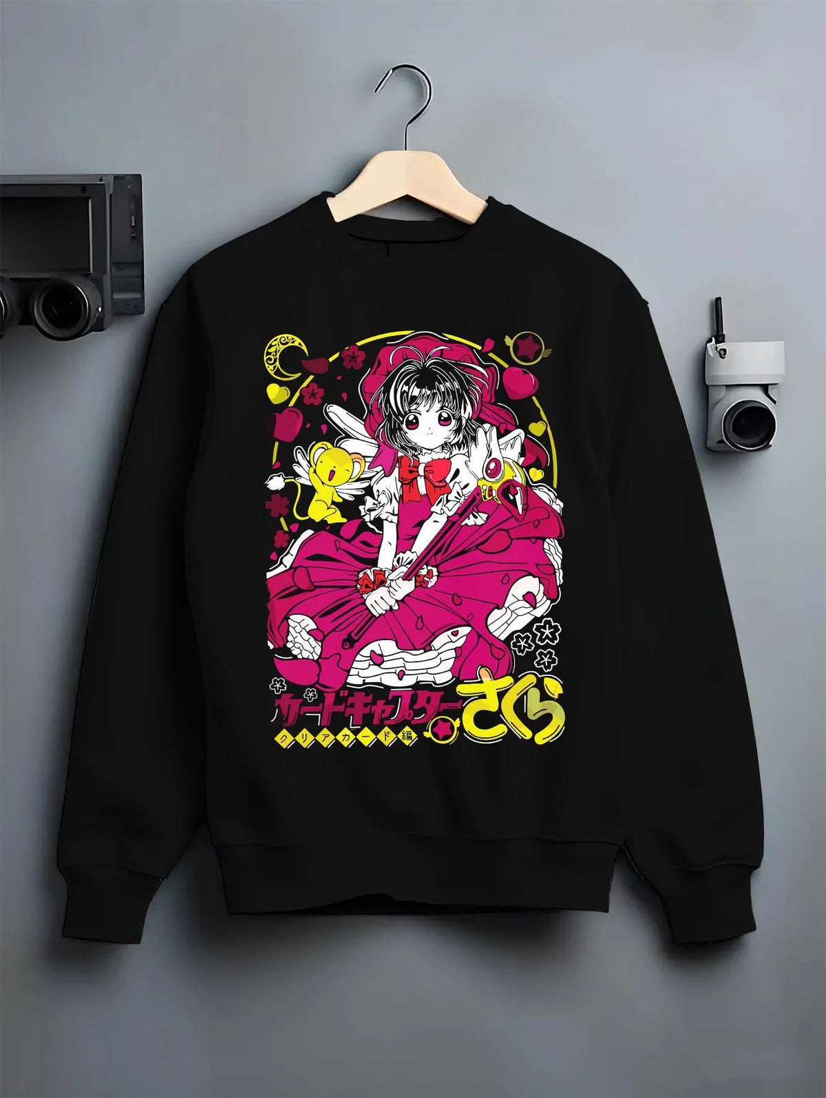 Black crewneck sweatshirt on hanger featuring Sakura Kinomoto with her magic wand artwork.