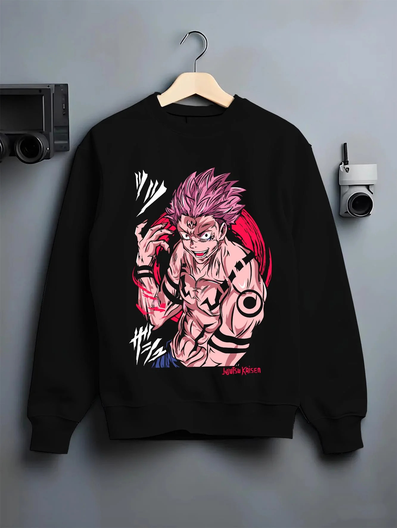 Black crewneck sweatshirt on hanger with Sukuna Hoodie Jujutsu Kaisen Cursed Mark Power graphic premium wear.
