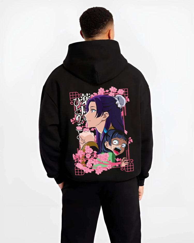 Black hoodie worn by male model, back view with Maomao Hoodie Apothecary Diaries Poison Tester Maid graphic bold anime graphic.