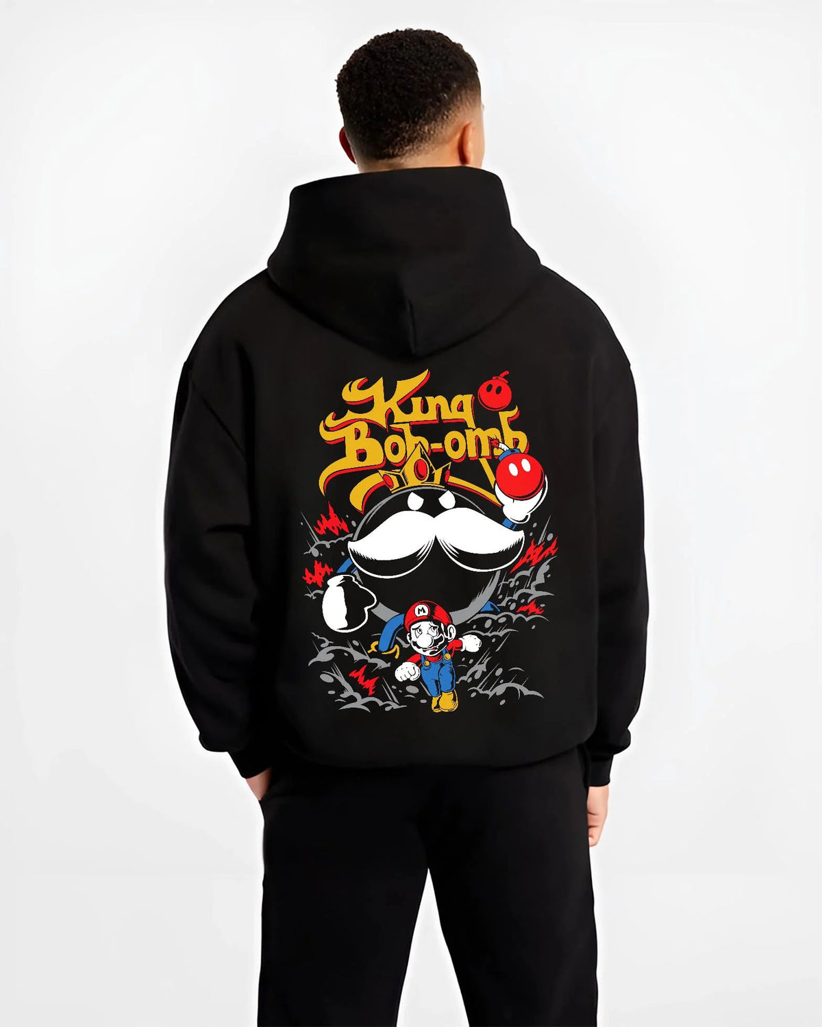 Black hoodie worn by male model from the back featuring Mario and King Bob-omb artwork.