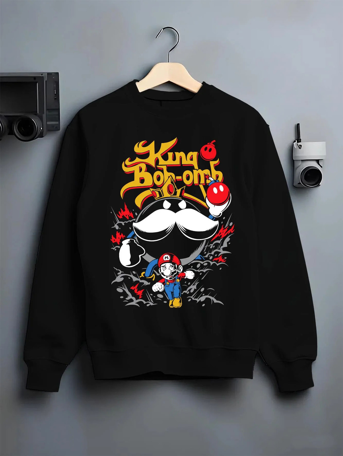 Black crewneck sweatshirt on hanger featuring Mario and King Bob-omb artwork.