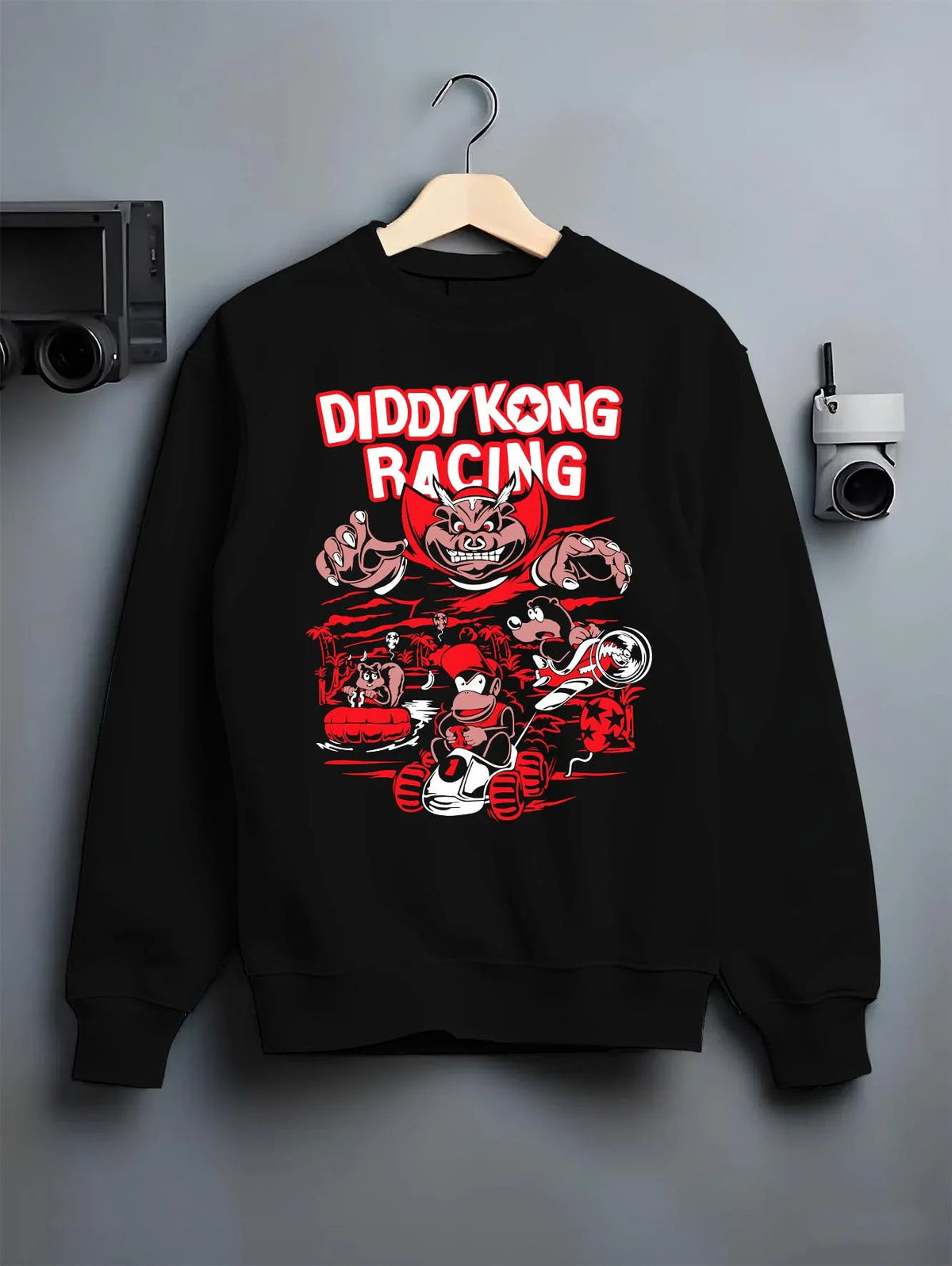 Black crewneck sweatshirt on hanger featuring Diddy Kong Racing kart action artwork.