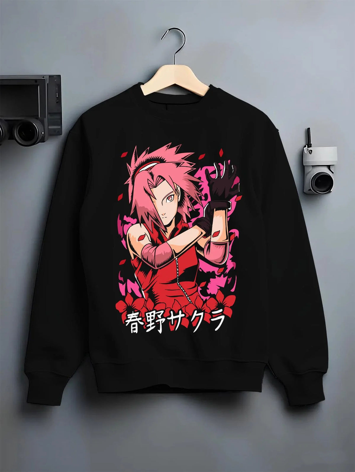 Black crewneck sweatshirt on hanger featuring Sakura Haruno medical ninja strength artwork.