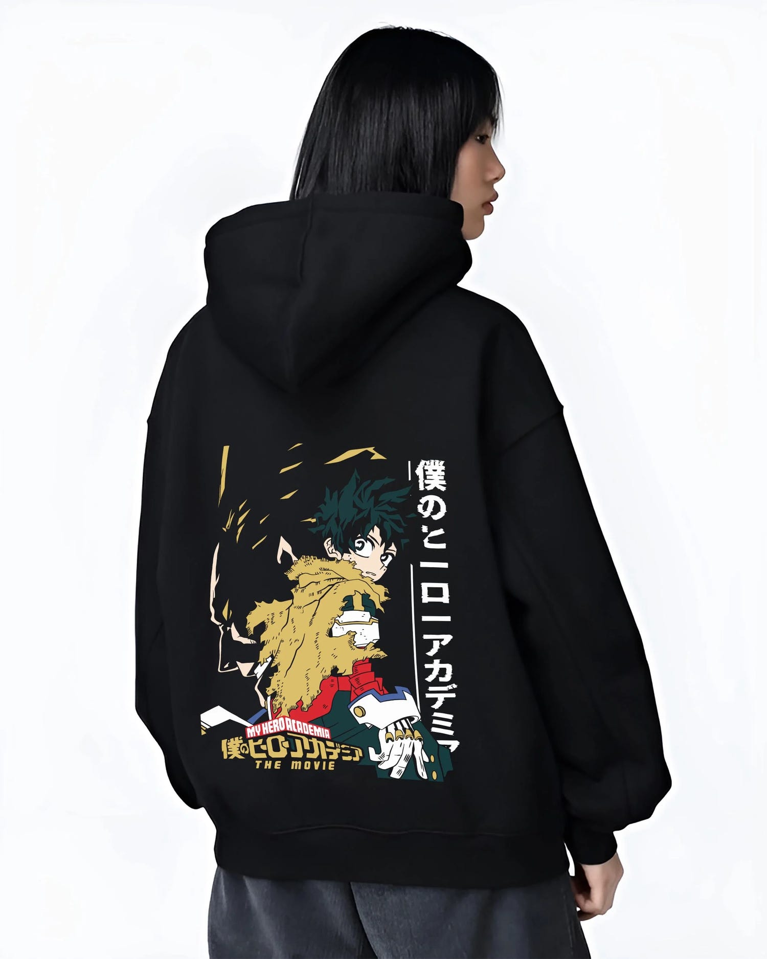Black hoodie worn by female model, back view with Izuku Midoriya Hoodie My Hero Academia Movie graphic bold anime graphic.