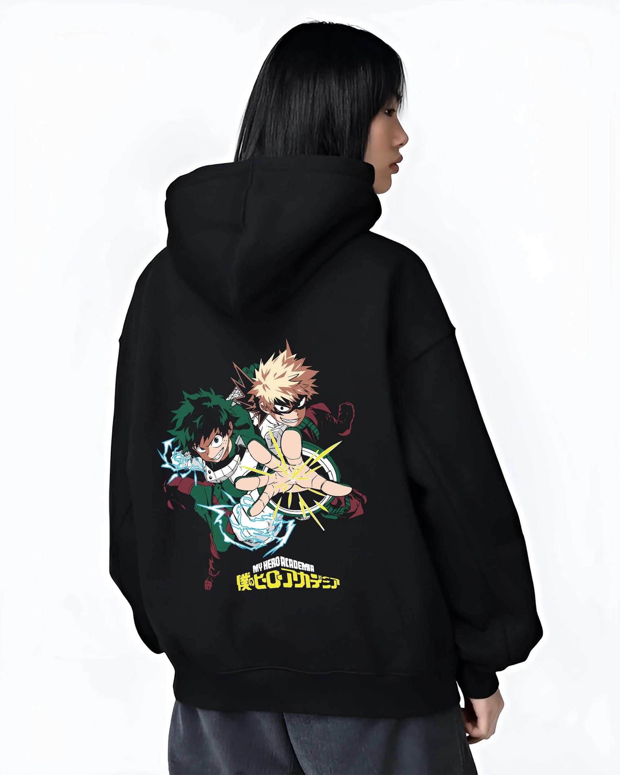 Black hoodie worn by female model, back view with Deku Bakugo Hoodie My Hero Academia Training Arc graphic bold anime graphic.