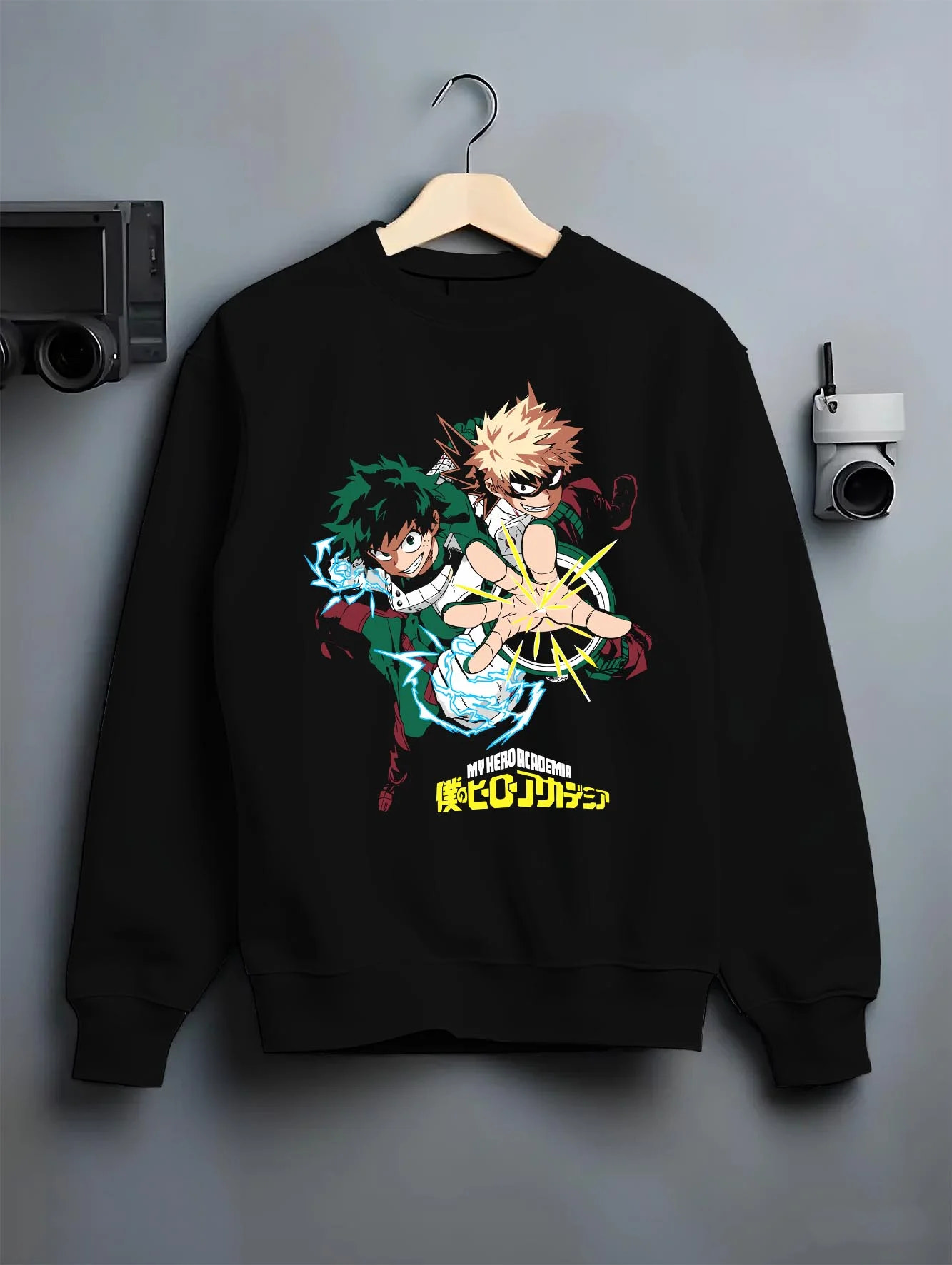 Black crewneck sweatshirt on hanger with Deku Bakugo Hoodie My Hero Academia Training Arc graphic premium wear.