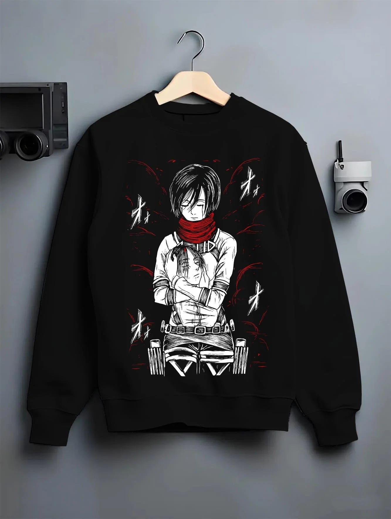 Black crewneck sweatshirt on hanger with Mikasa Ackerman Hoodie Attack on Titan Winter Gear graphic premium wear.