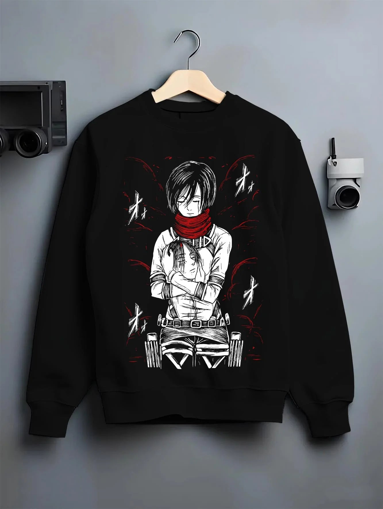 Black crewneck sweatshirt on hanger with Mikasa Ackerman Hoodie Attack on Titan Winter Gear graphic premium wear.