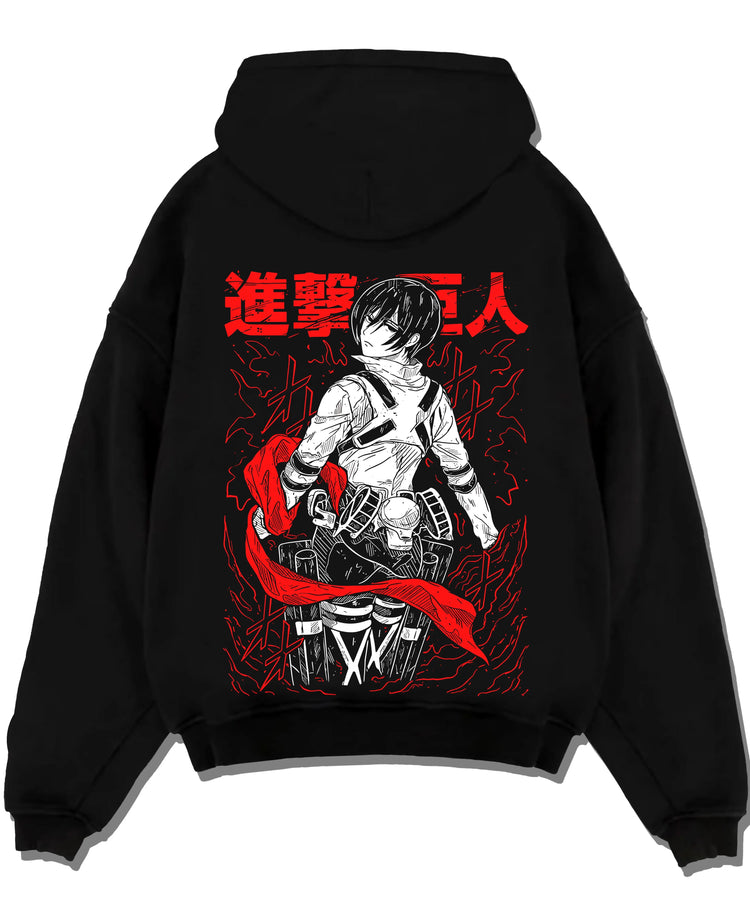 Black pullover hoodie laid flat, featuring anime poster inspired artwork of Mikasa Ackerman from Attack on Titan with red scarf.