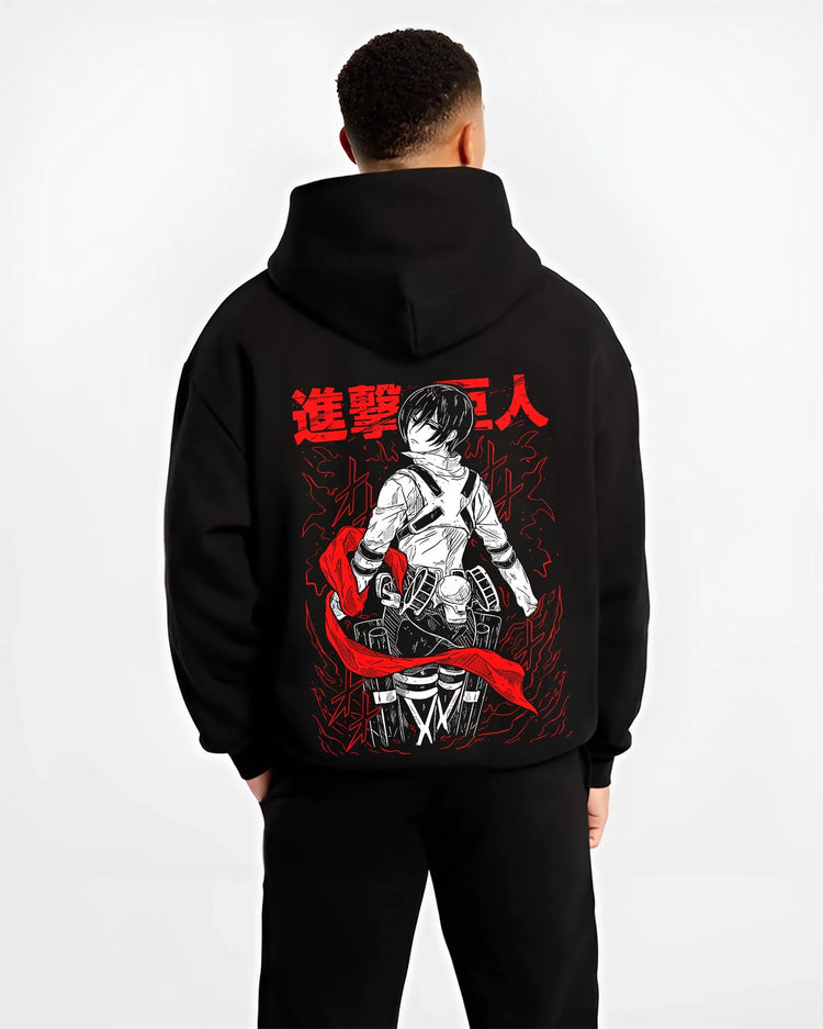 Black hoodie worn by male model, back view, showing retro manga graphic of Mikasa Ackerman in Survey Corps uniform.