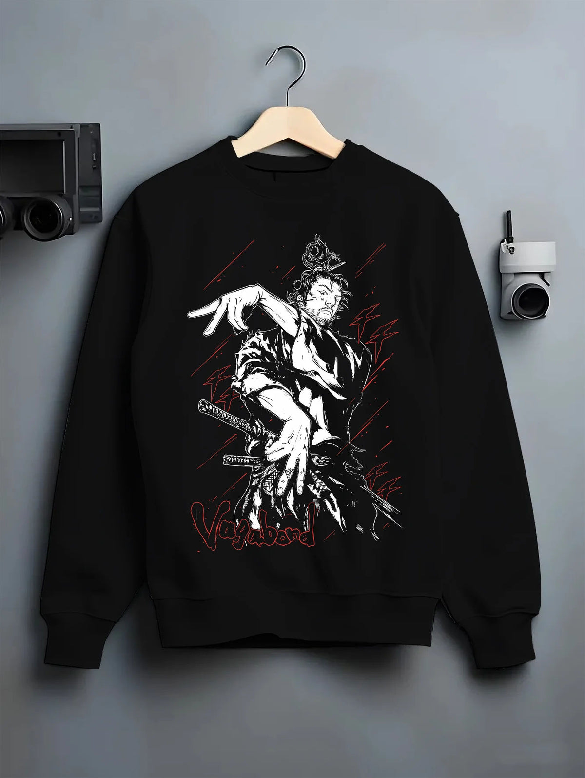 Black crewneck sweatshirt on hanger showing Miyamoto Musashi from Vagabond: sword action scene