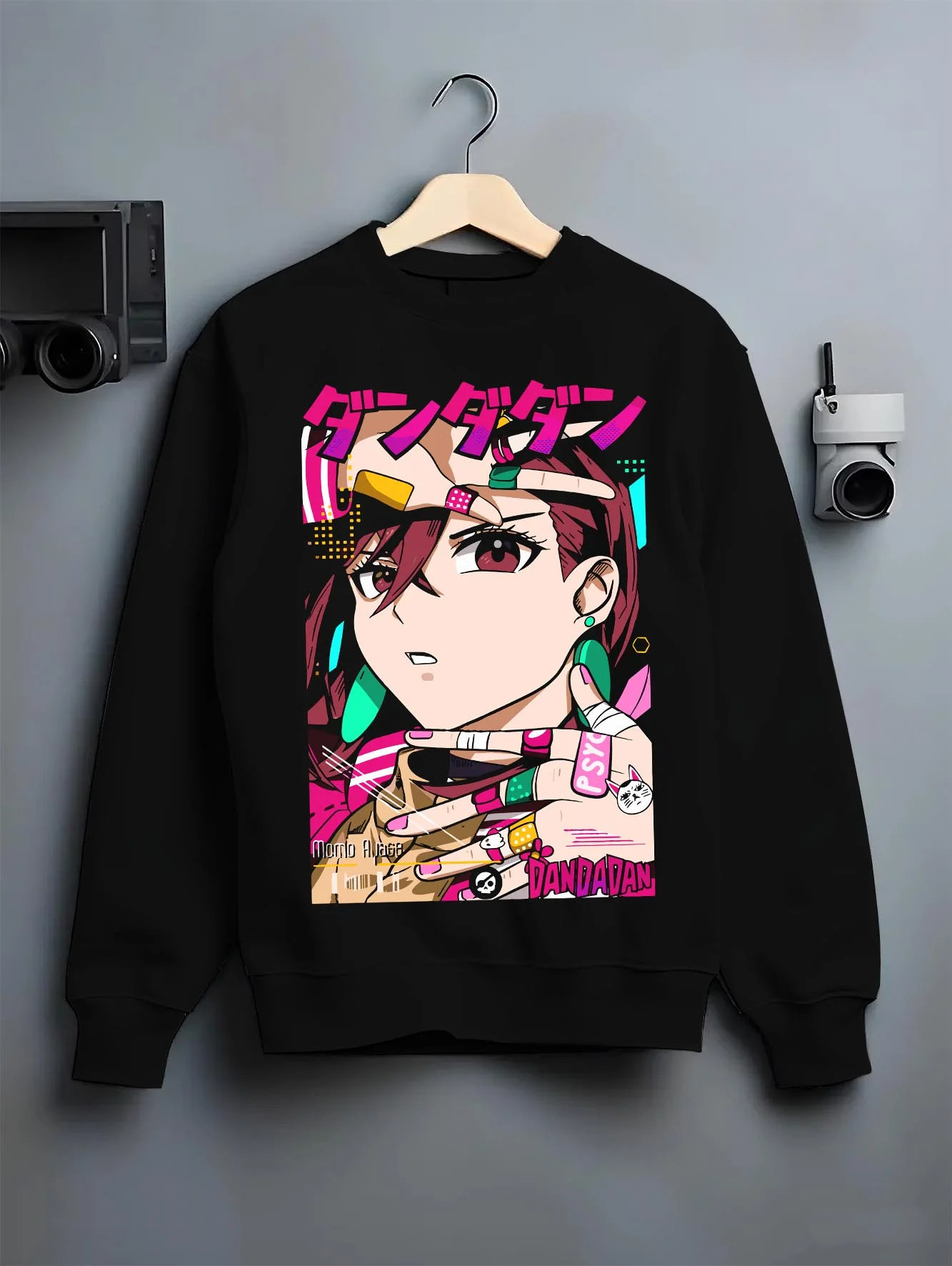 Black crewneck sweatshirt on hanger with Momo Ayase Hoodie Dandadan Paranormal Girl Fighter graphic streetwear graphic.