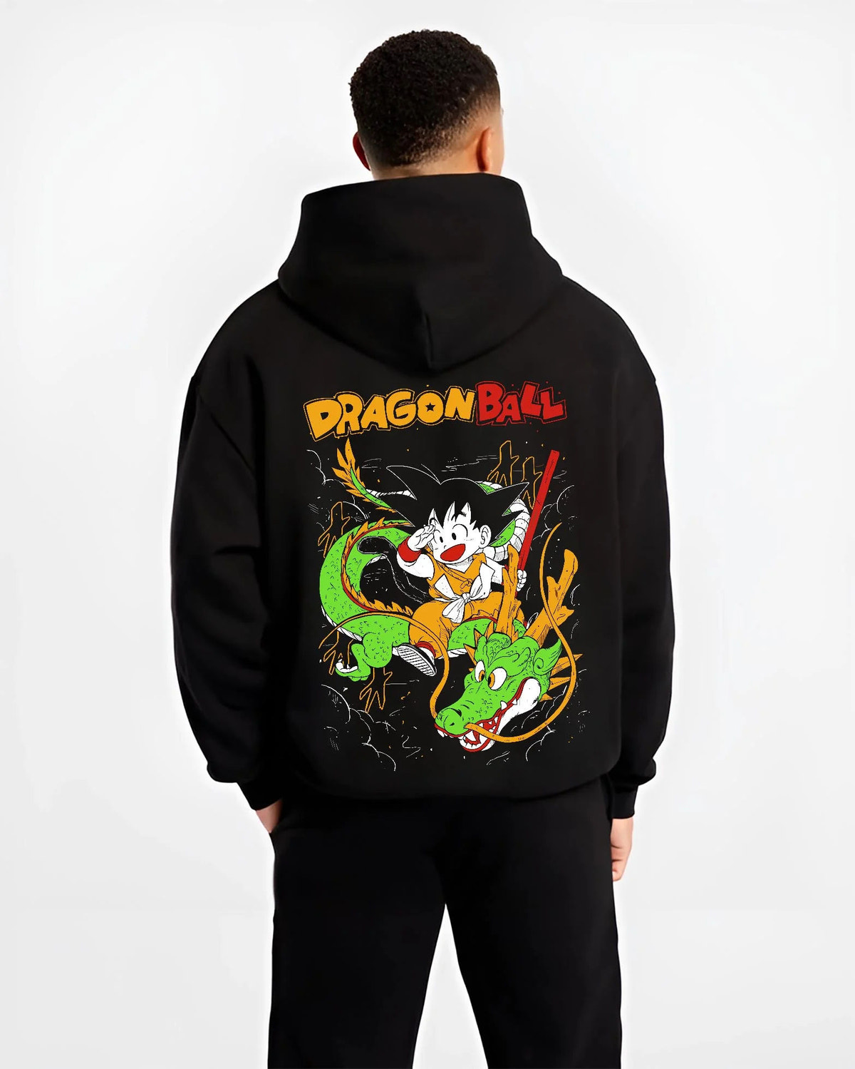 Black hoodie worn by male model from the back featuring Kid Goku and Shenron artwork.
