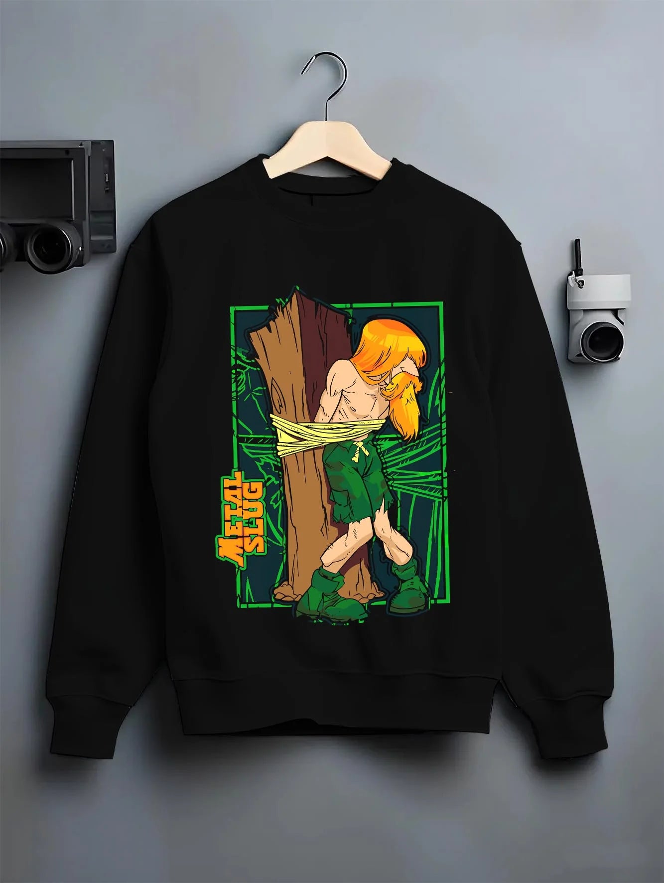 Black crewneck sweatshirt on hanger with Metal Slug Hoodie Classic Game Retro Capture graphic premium wear.