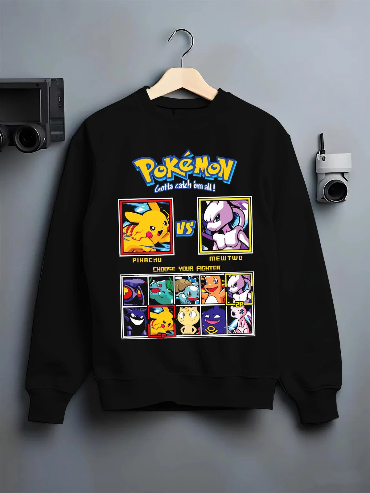 Black crewneck sweatshirt on hanger featuring Pikachu, Mewtwo and classic Pokemon artwork.