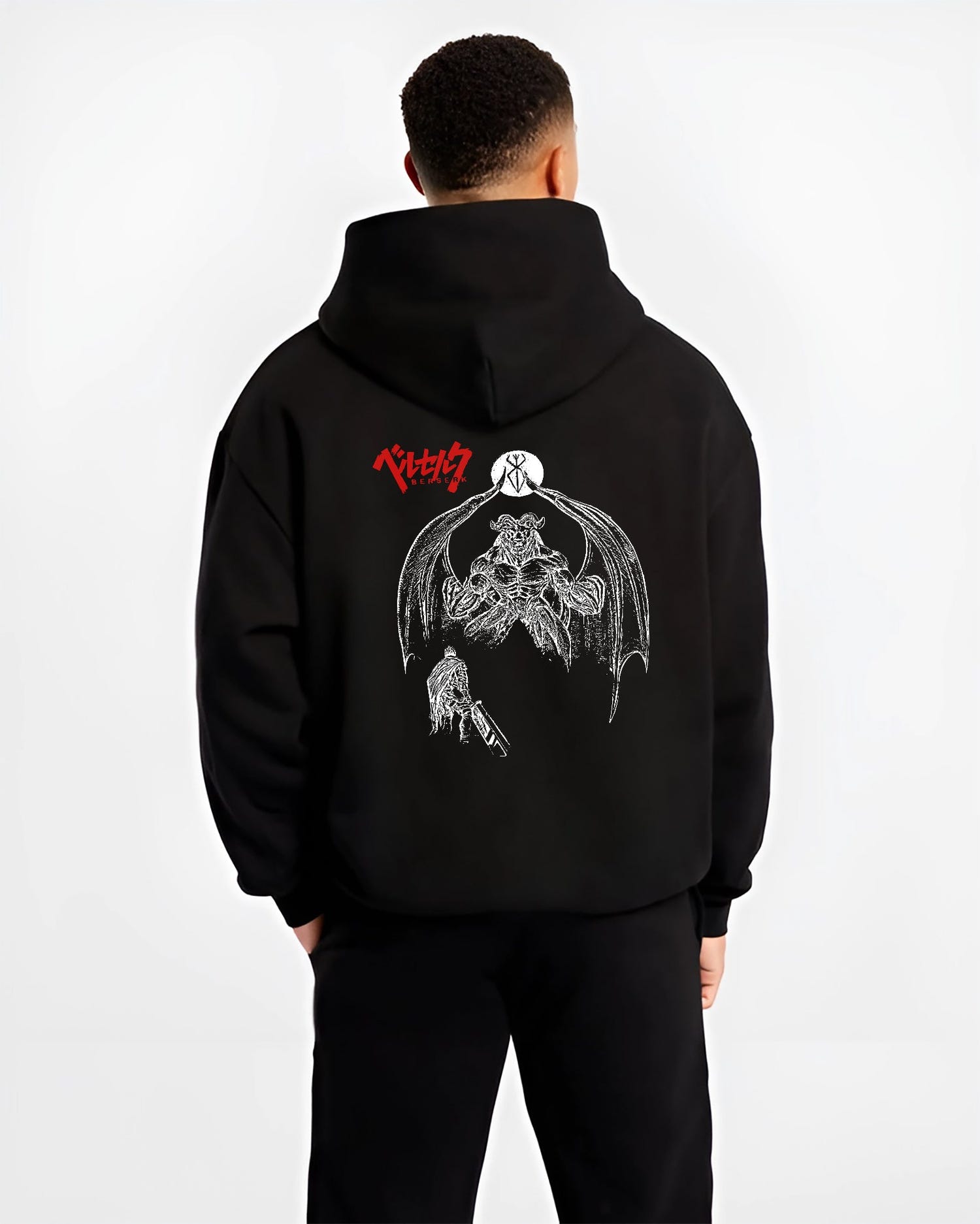 Black hoodie worn by a male model, back view, featuring Berserk Guts retro manga graphic with dark apostle figure and bold battle illustration.