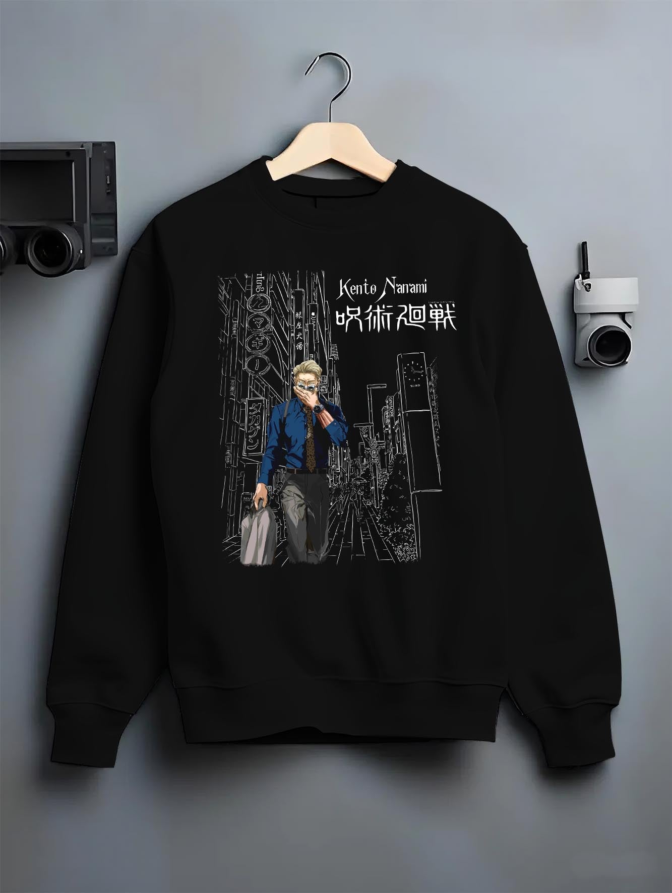 Black crewneck sweatshirt on a hanger against a grey wall, featuring Jujutsu Kaisen Nanami Kento Japanese animation streetwear artwork with bold city backdrop design.