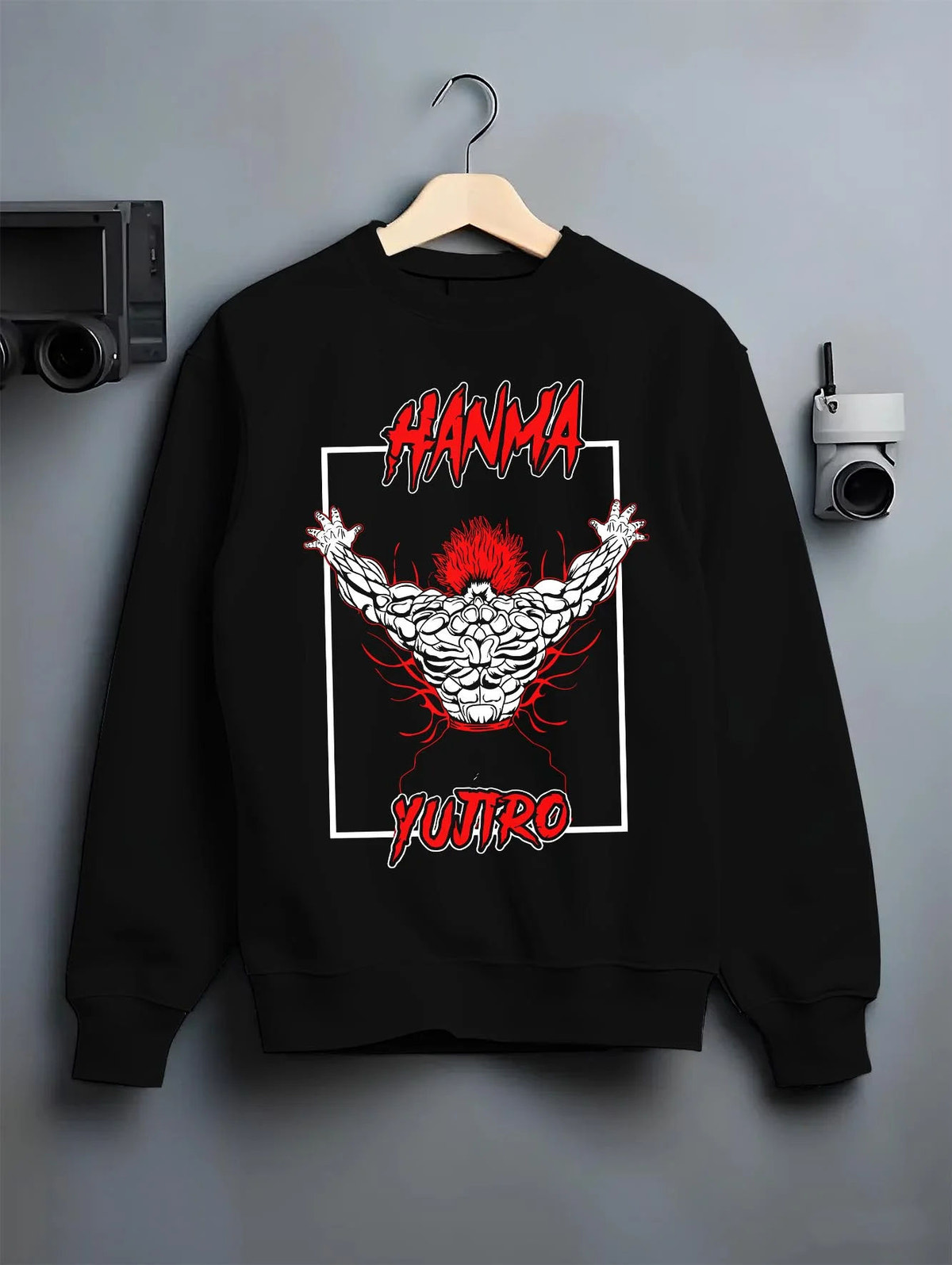 Black crewneck sweatshirt on hanger featuring Yujiro Hanma demon back Baki artwork.