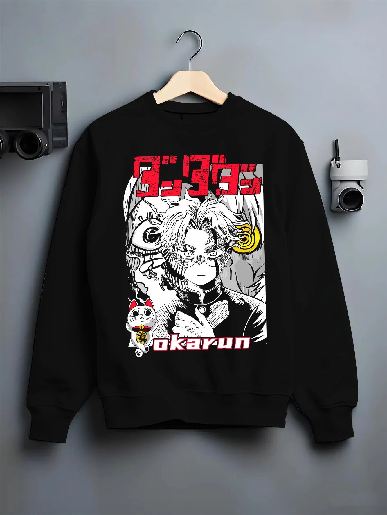 Black crewneck sweatshirt on hanger with Okarun Hoodie Dandadan Paranormal Occult Fighter graphic Okarun anime design.