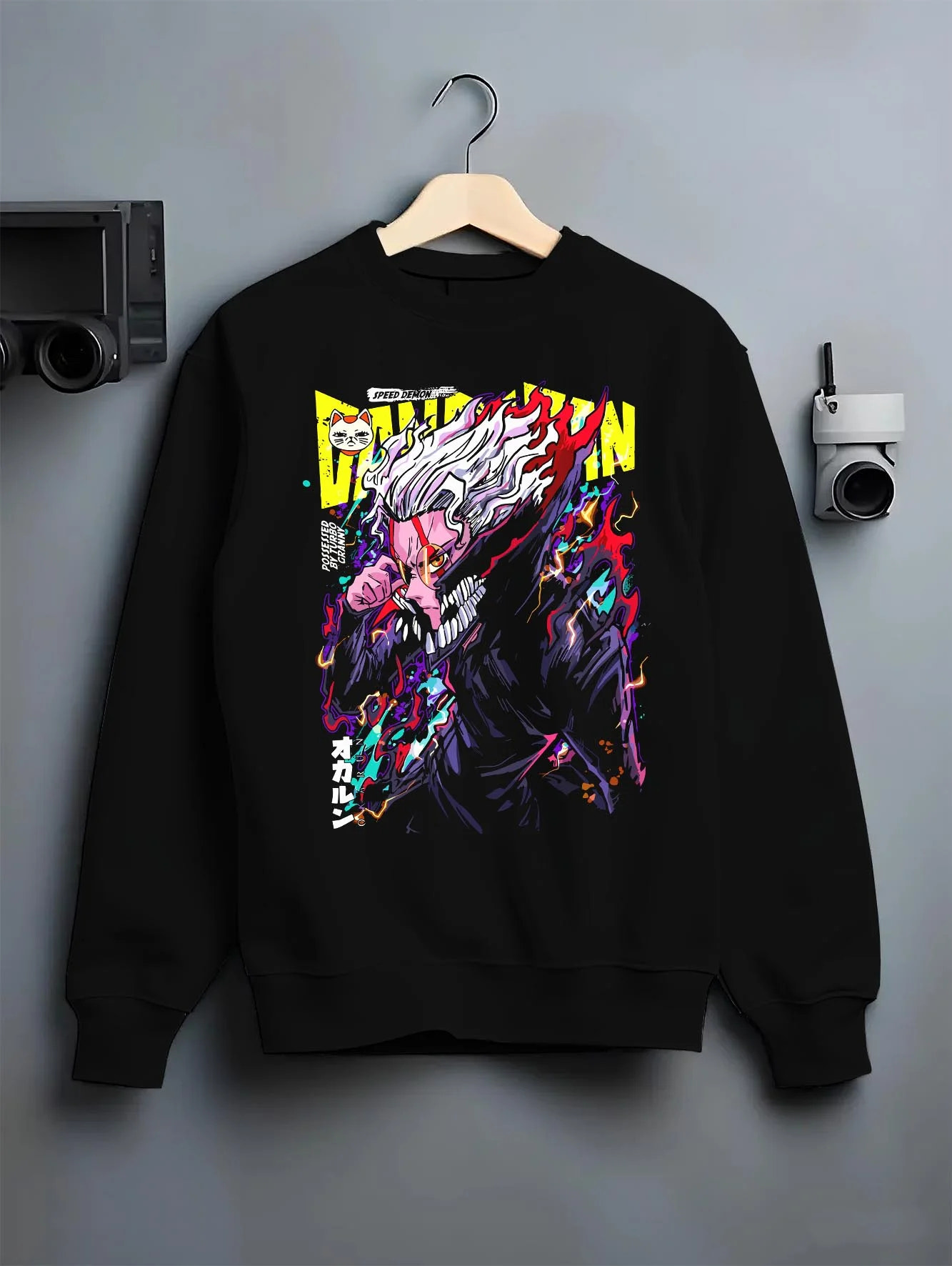 Black crewneck sweatshirt on hanger with Turbo Granny Hoodie Dandadan Monster Spirit Fighter graphic bold anime graphic.