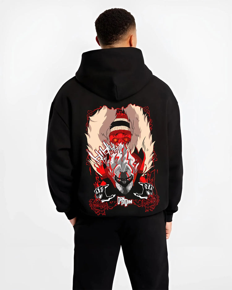 Black hoodie worn by male model, back view with Turbo Granny Dandadan Hoodie Retro Yokai Anime Horror graphic premium wear.